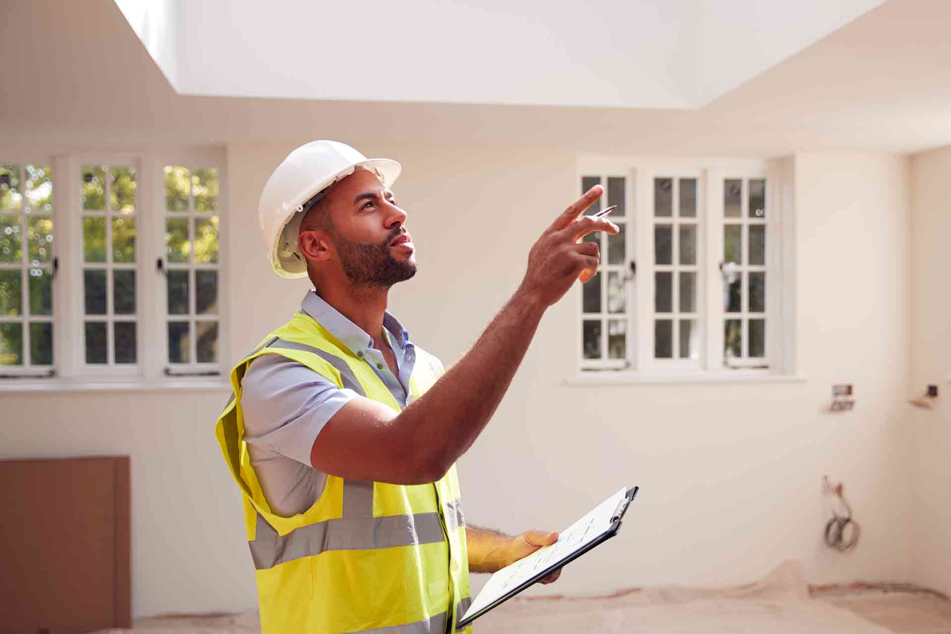 Third Party Wall Surveyors Norwich reviewing plans between two parties during a dispute